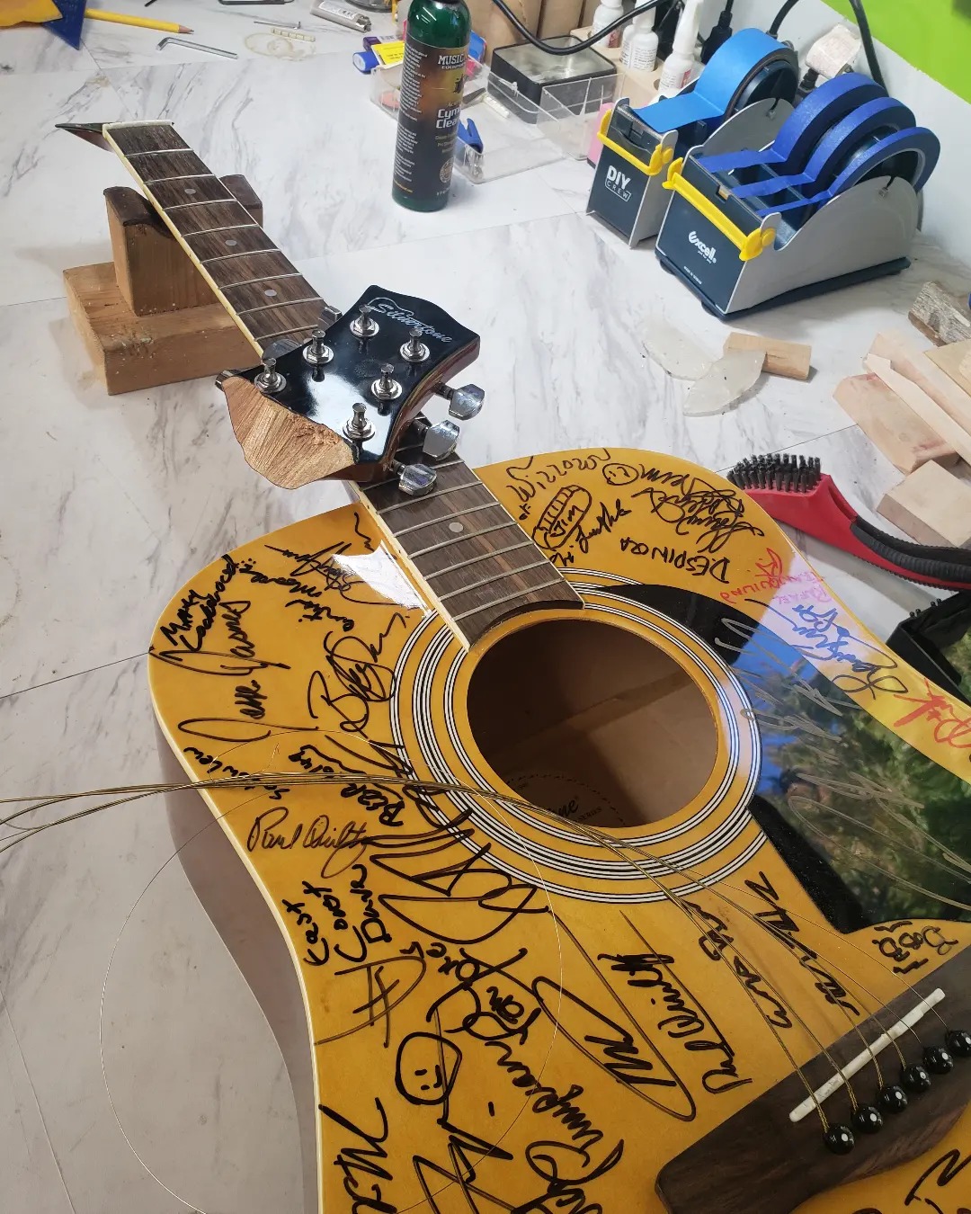 Broken headstock on the Madison signature guitar, before repair