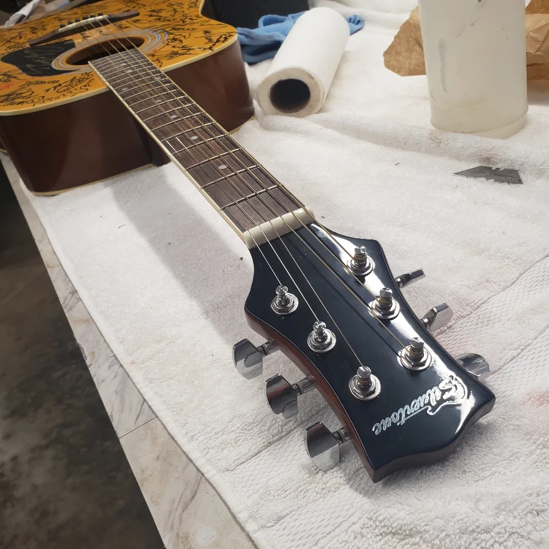 Broken headstock on the Madison signature guitar, after repair